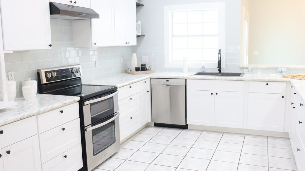 Modern kitchen with quartz countertops and tile backsplash